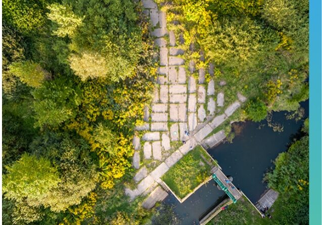 Aerial view of a water control structure and concrete pathway managed by stormwater compliance experts.